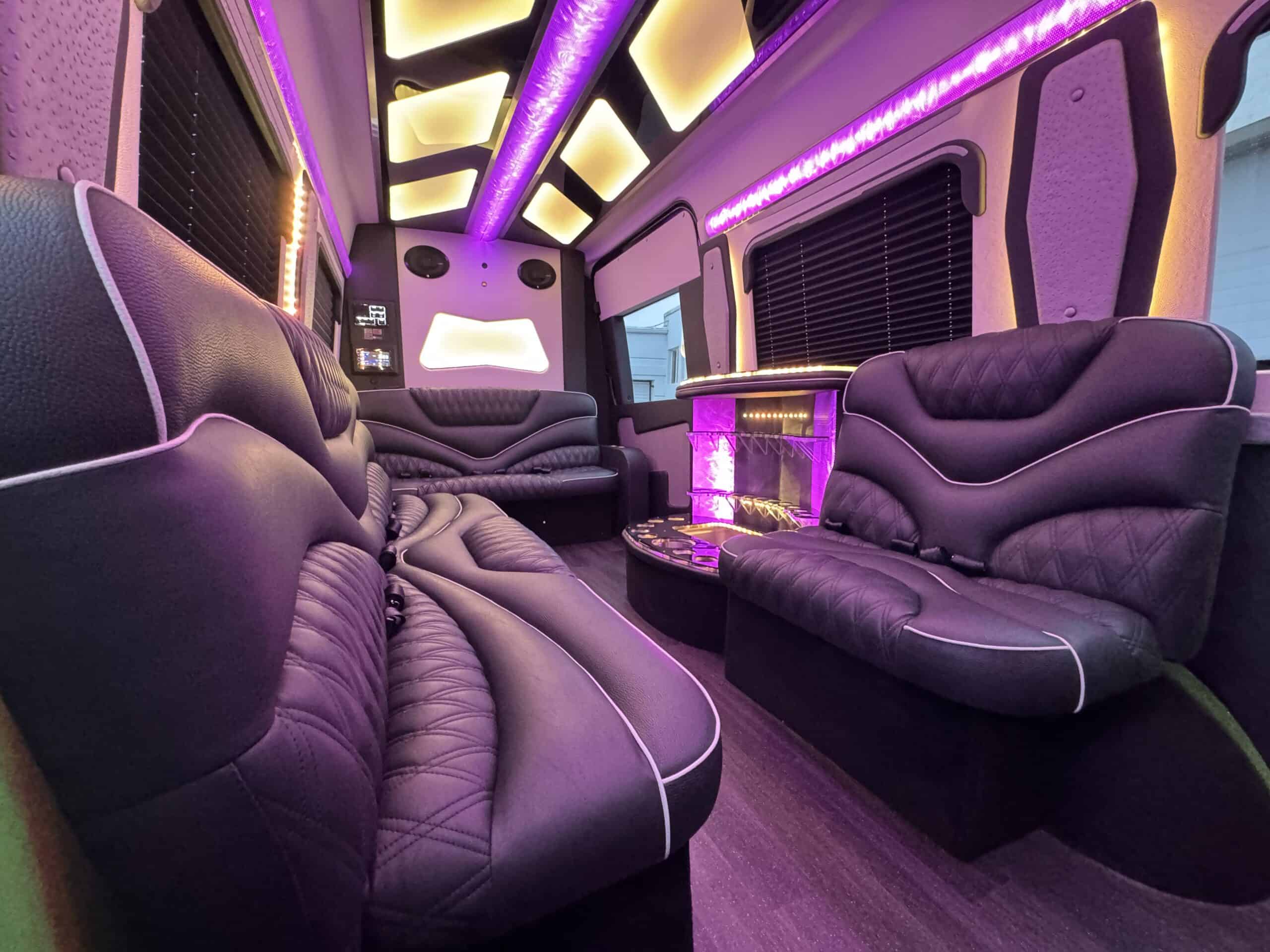 Elegant limousine interior with plush leather seats and vibrant LED lighting.