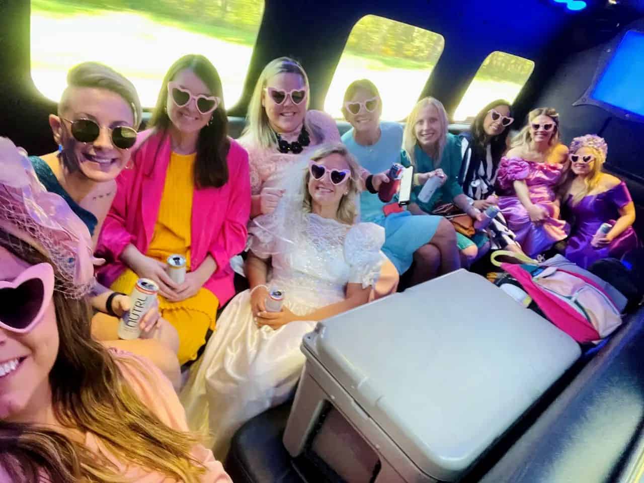 Luxury Limousine Party with Friends Group of women enjoying a limousine ride with pink sunglasses and drinks.